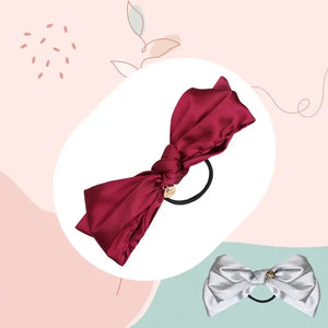 Peach banner with product images of burgundy & grey ponytail holders, promoting pony holders collection